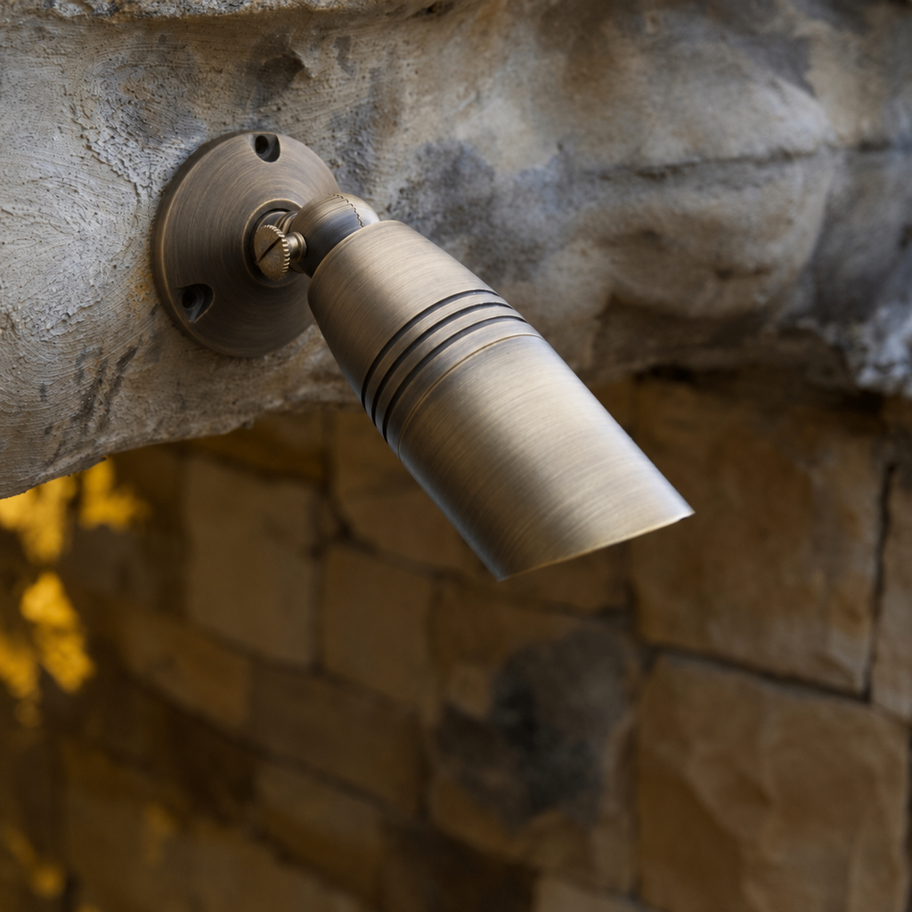 Heavy-duty solid brass lighting fixture base with threaded mounting hub and three-point screw attachment, designed for durable outdoor landscape lighting installations.
