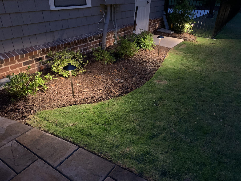 Landscape lighting in a garden with grass and plants marietta, ga